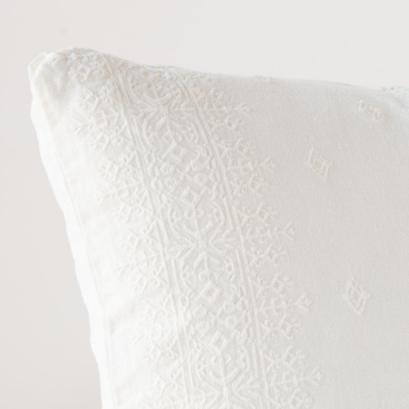 Ines Throw Pillow | Winter White | Close-up of pillow corner, showcasing the embroidery pattern detail.