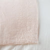 Ines Blanket | Pearl | Close-up of corner against a white background, showcasing embroidery pattern detail - overhead view.