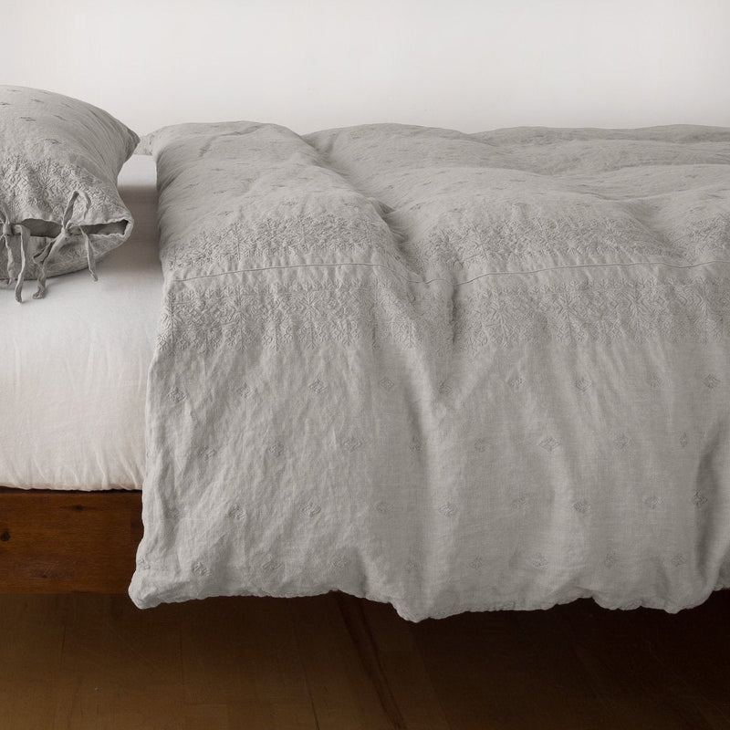 Ines Duvet Cover | Fog | lightly rumpled duvet cover on a monochromatic bed against a white background - side view.