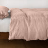Ines Duvet Cover | Rouge | lightly rumpled duvet cover on a monochromatic bed against a white background - side view.