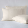 Ines Sham | Parchment | two shams leaning upright and one laying flat at an angle, against a white background.