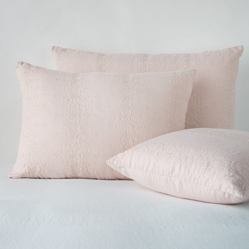 Ines Sham | Pearl | two shams leaning upright and one laying flat at an angle, against a white background.