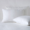 Ines Sham | White | two shams leaning upright and one laying flat at an angle, against a white background.