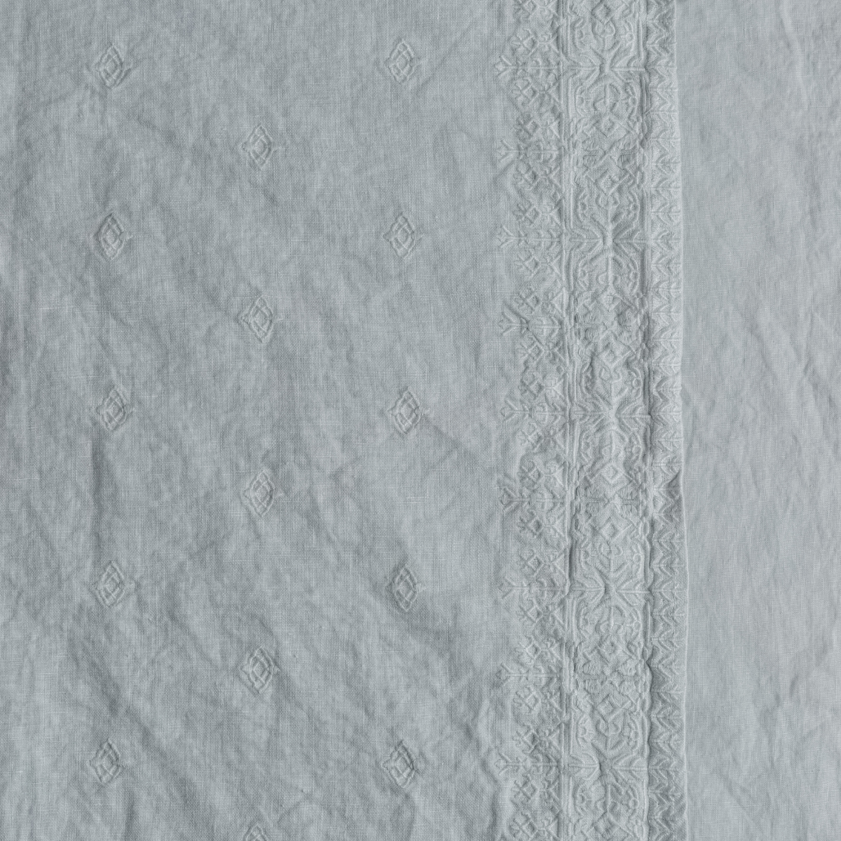 Ines Sham | Cloud | A close up of embroidered midweight linen fabric in cloud, a soft, subtle sky blue-grey.