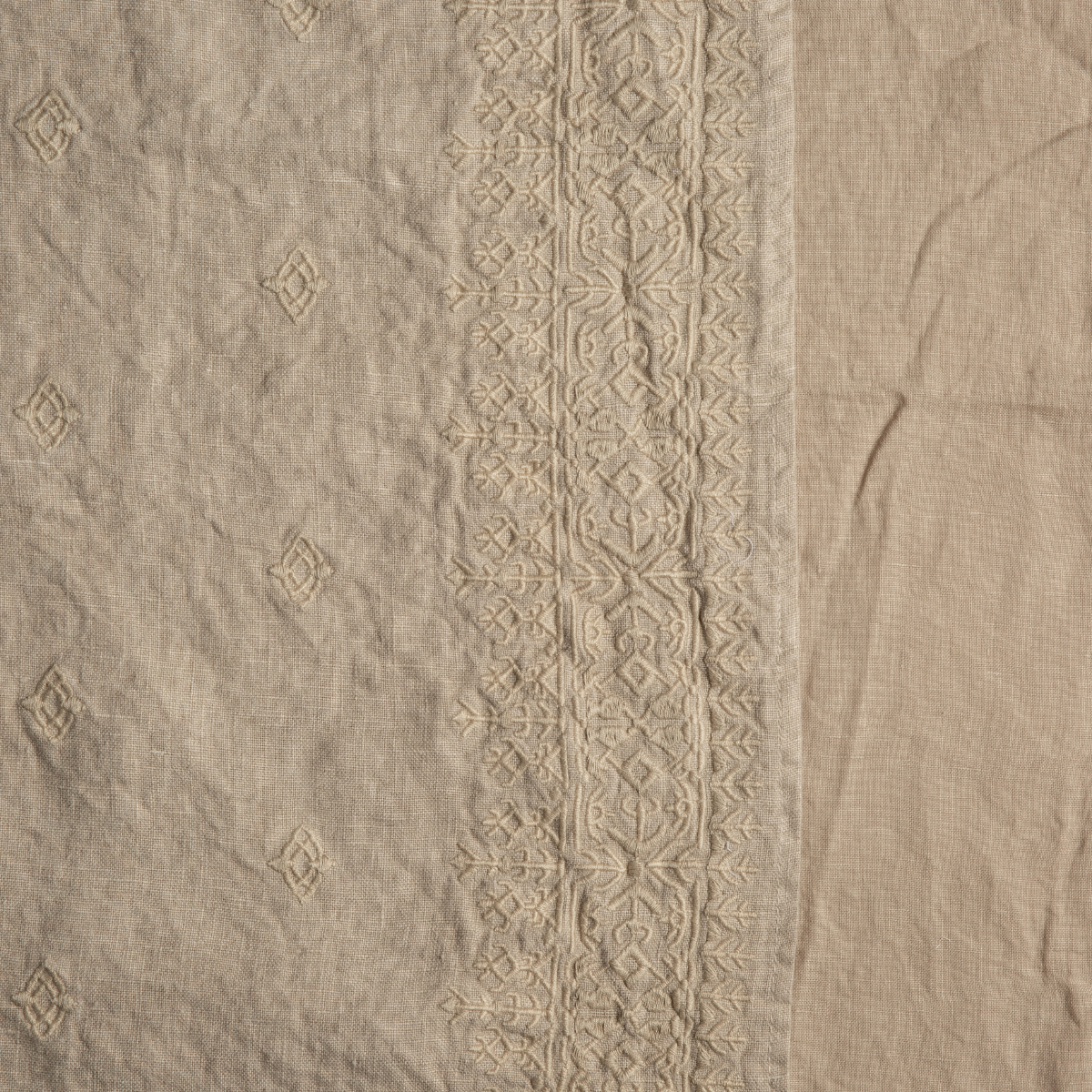 Ines Baby Blanket | Honeycomb | A close up of embroidered midweight linen fabric in honeycomb, a warm golden tone.