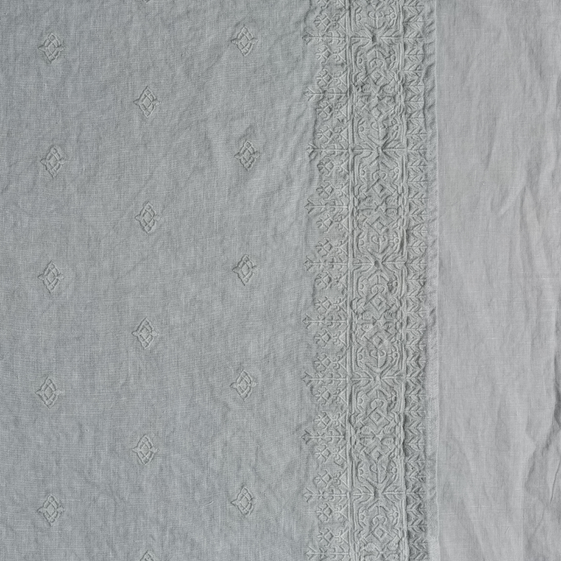 Ines Duvet Cover | Mineral | A close up of embroidered midweight linen fabric in mineral, a soothing seafoam blue with subtle grey-green undertones.
