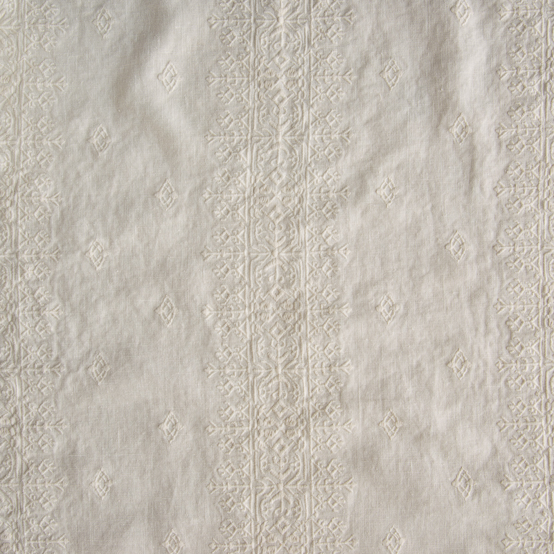 Ines Sham | Parchment | A close up of embroidered midweight linen fabric in parchment, a warm, antiqued cream.