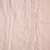 Ines Swatch Card | Pearl | A close up of embroidered midweight linen fabric in pearl, a nude-like, soft rose pink tone.