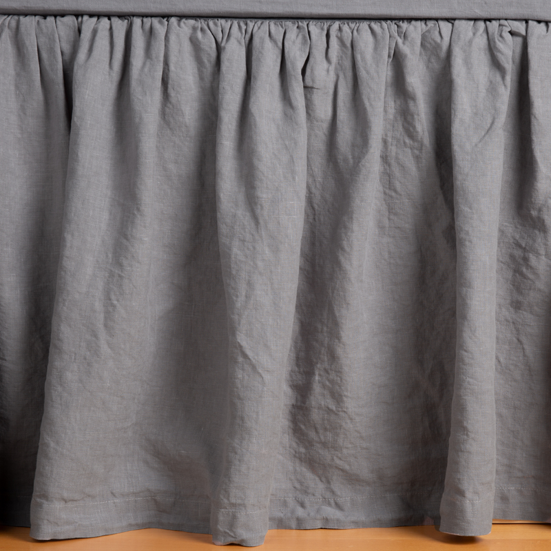 Linen Twin Bed Skirt | French Lavender | linen bed skirt shown with matching fitted sheet shown gently grazing the floor.