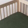Juniper | linen crib sheet shown on a crib mattress shot slightly overhead into the inside corner of the crib.