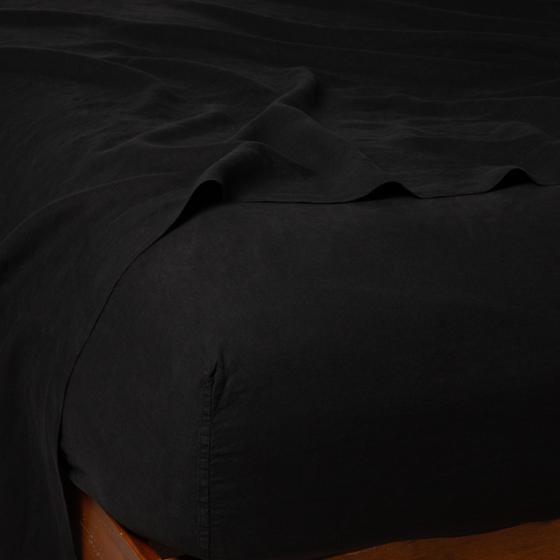 Linen Twin Fitted Sheets | Corvino | close up of fitted sheet with matching rumpled flat sheet - corner view.