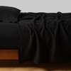 Linen Fitted Sheet | Corvino | fitted sheet with matching rumpled flat sheet and sleeping pillow - side view.