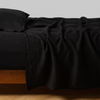 Linen Flat Sheet | Corvino | Rumpled linen sheeting with matching sleeping pillow - side view.
