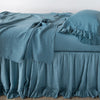 Linen Whisper Bed Skirt | Cenote | bed skirt layered with monochromatic linen sheeting - side view.