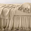 Linen Whisper Bed Skirt | Honeycomb | bed skirt layered with monochromatic linen sheeting - side view.