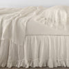 Linen Whisper Bed Skirt | Parchment | bed skirt layered with monochromatic linen sheeting - side view.