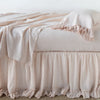 Linen Whisper Bed Skirt | Pearl | bed skirt layered with monochromatic linen sheeting - side view.