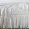 Linen Whisper Bed Skirt | Winter White | bed skirt layered with monochromatic linen sheeting - side view.
