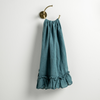 Linen Whisper Guest Towel | Cenote | guest towel draped through a decorative brass towel ring, against a white wall.