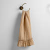 Linen Whisper Guest Towel | Honeycomb | guest towel draped through a decorative brass towel ring, against a white wall.
