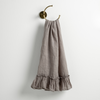 Linen Whisper Guest Towel | Moonlight | guest towel draped through a decorative brass towel ring, against a white wall.