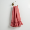 Linen Whisper Guest Towel | Poppy | guest towel draped through a decorative brass towel ring, against a white wall.