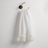 Linen Whisper Guest Towel | Winter White | guest towel draped through a decorative brass towel ring, against a white wall.