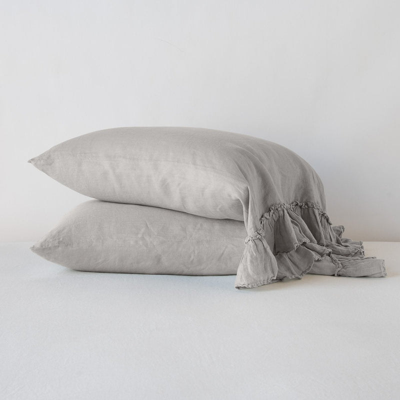 Linen Whisper Pillowcase (Single) | Fog | Two Linen Whisper sleeping pillows, stacked at a slight angle against a plain background, showcasing ruffle trim detail - fog, side view.