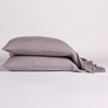 Linen Whisper Pillowcase (Single) | French Lavender | pair of ruffled linen pillowcases stacked on a plain white background.