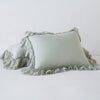 Linen Whisper Sham | Eucalyptus | standard sham leaning against a king sham laying flat, on a plain background.