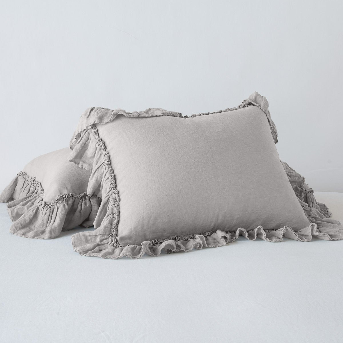 Linen Whisper Sham | Fog | standard sham leaning against a king sham laying flat, on a plain background.