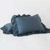 Linen Whisper Sham | Midnight | standard sham leaning against a king sham laying flat, on a plain background.