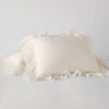 Linen Whisper Sham | Parchment | standard sham leaning against a king sham laying flat, on a plain background.