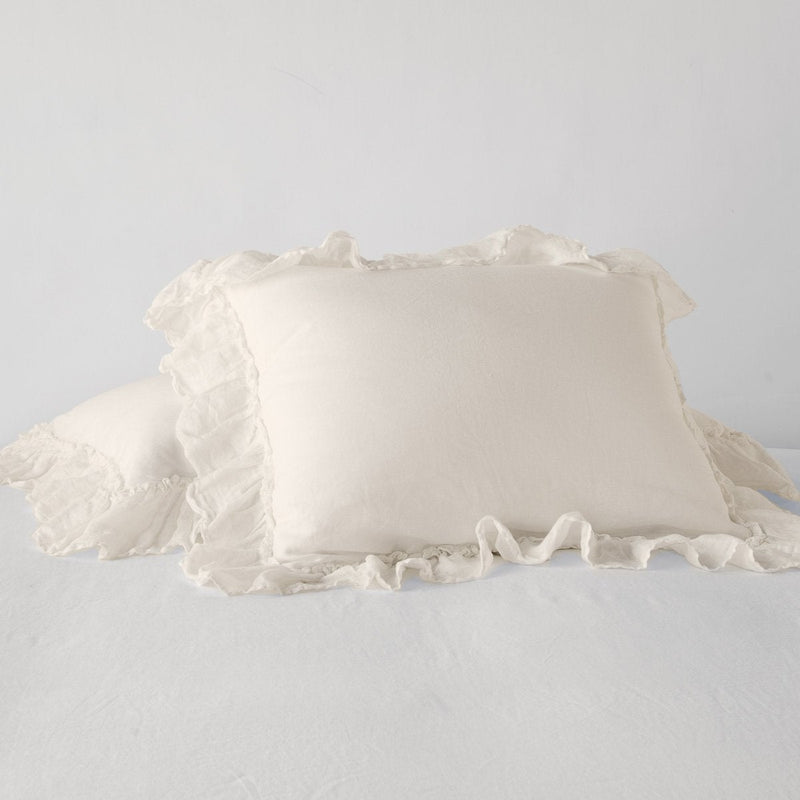 Linen Whisper Sham | Parchment | standard sham leaning against a king sham laying flat, on a plain background.