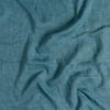 Linen Whisper Crib Skirt | Cenote | A close up of linen whisper fabric in cenote, a vibrant, ocean-inspired blue-green.