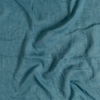 Linen Whisper Yardage | Cenote | A close up of linen whisper fabric in cenote, a vibrant, ocean-inspired blue-green.