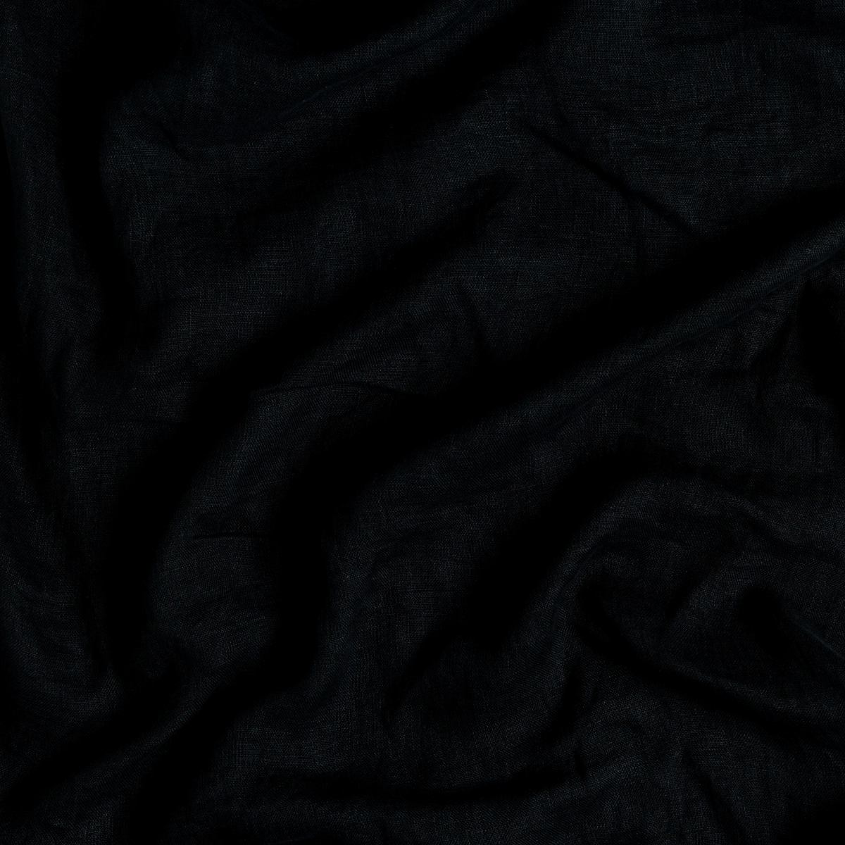 Linen Whisper Bed Skirt | Corvino | A close up of linen whisper fabric in Corvino, a black tone.