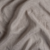Linen Whisper Crib Skirt | Fog | A close up of linen whisper fabric in fog, a neutral-warm, soft mid-tone grey.