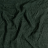 Linen Whisper Bed Skirt | Juniper | A close up of linen whisper fabric in Juniper, a deep green tone.