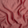 Linen Whisper Baby Blanket | Poppy | A close up of linen whisper fabric in poppy, a warm coral pink.