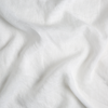 Linen Whisper Crib Skirt | White | A close up of linen whisper fabric in classic white.