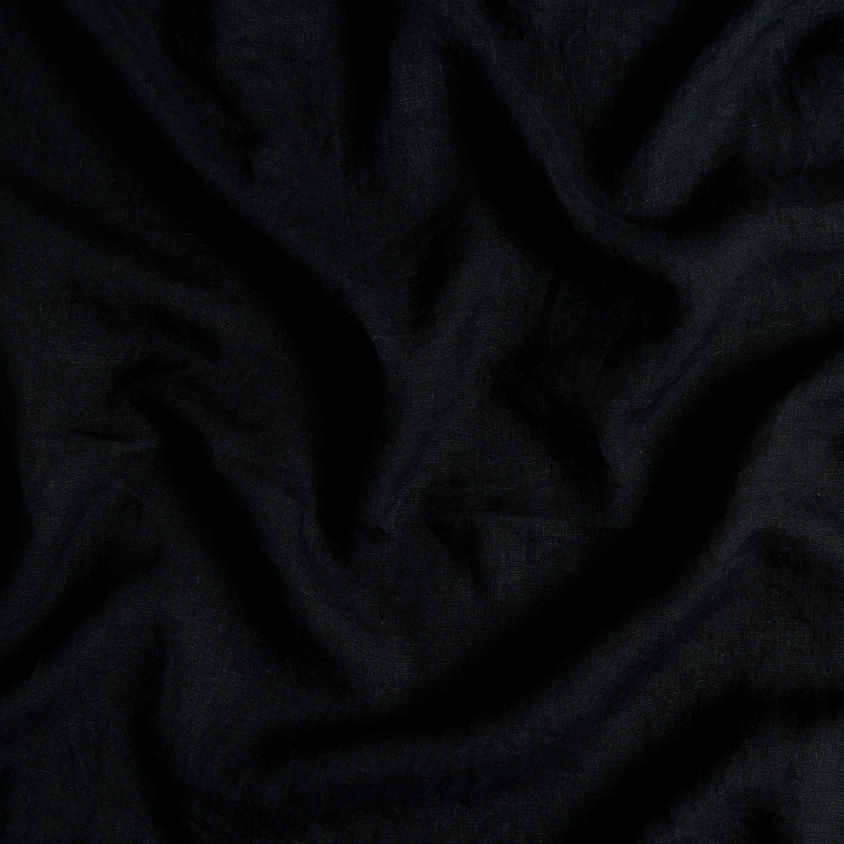 Linen Bed Skirt | Corvino | A close up of linen fabric in Corvino, a black tone.