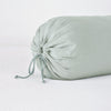 Linen Throw Pillow | Eucalyptus | Close-up bolster end detail, angled view to show gathered closure and satin ties.