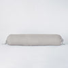 Linen Throw Pillow | Linen bolster in fog against a plain background.