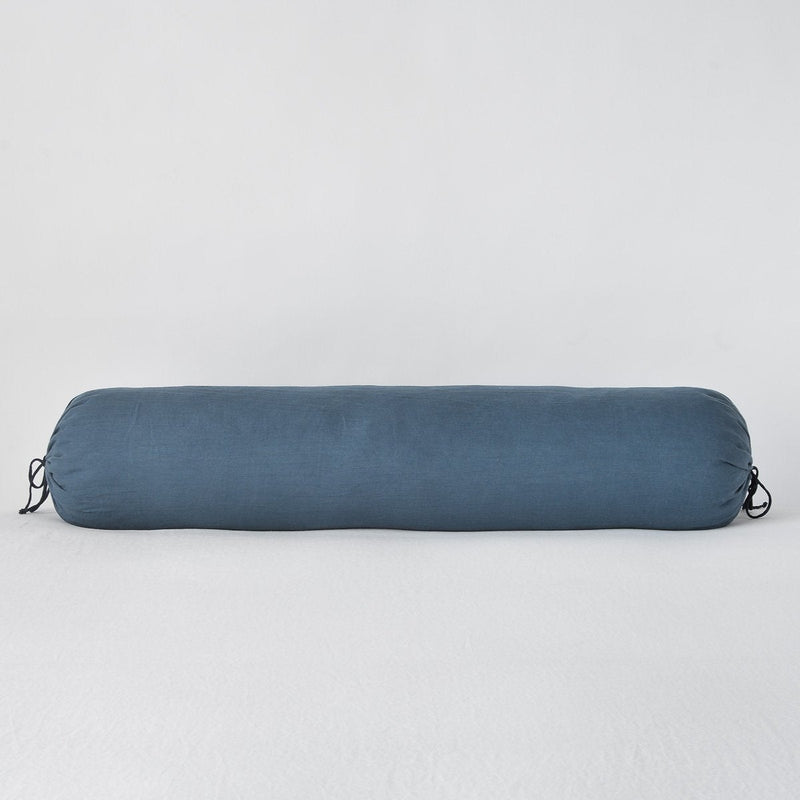 Linen Throw Pillow | Midnight | Linen bolster in midnight against a plain background.