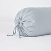 Linen Throw Pillow | Mineral | Close-up of Linen bolster end detail in mineral, angled to show gathering and satin ties.