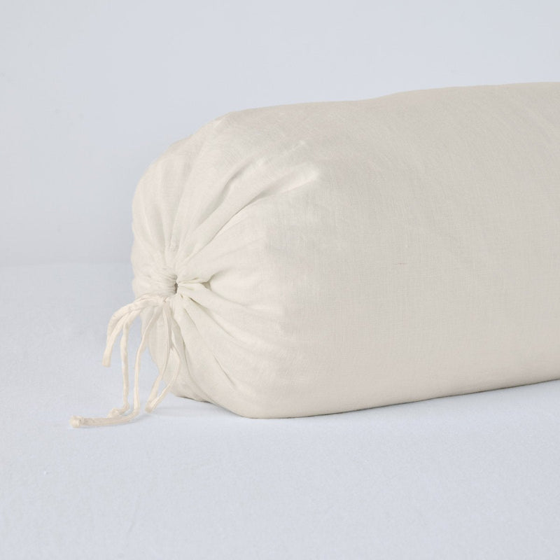 Linen Throw Pillow | Parchment | Close-up bolster end detail, angled view to show gathered closure and satin ties.