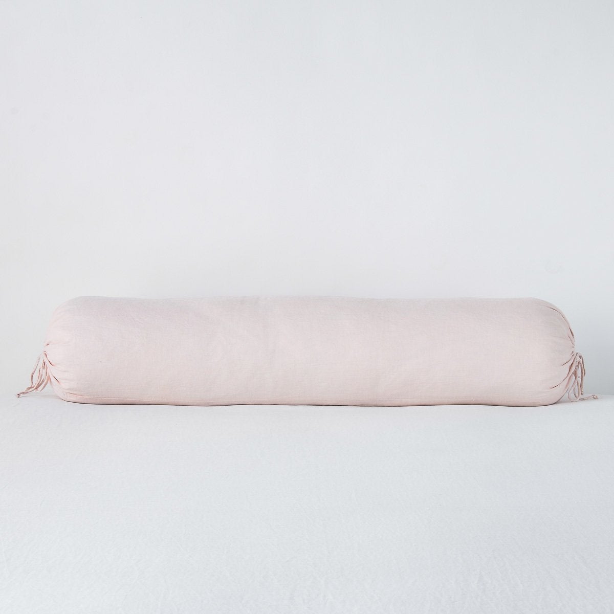 Linen Throw Pillow | Pearl | bolster against a white background.