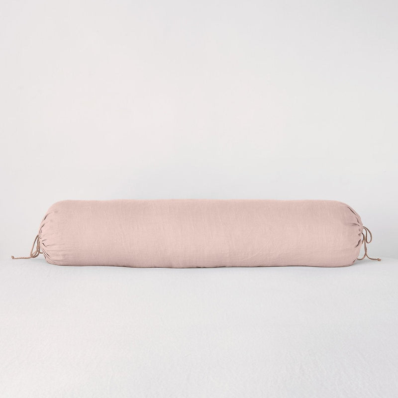 Linen Throw Pillow | Rouge | bolster against a white background.