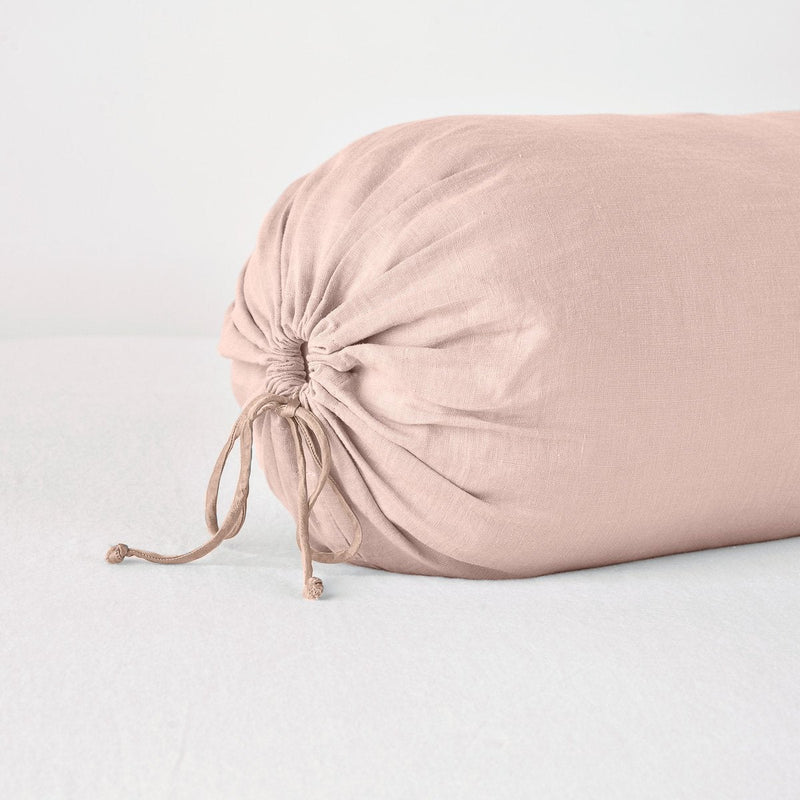 Linen Throw Pillow | Rouge | Close-up bolster end detail, angled view to show gathered closure and satin ties.